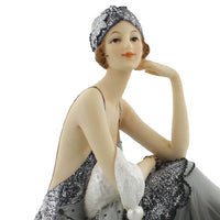 Art Deco seated lady figurine in silver and grey evening gown
