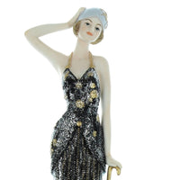 Art Deco lady figurine in black and gold evening gown holding umbrella