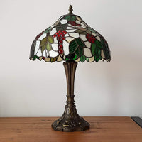 Stained glass lamp with leaf and berry design