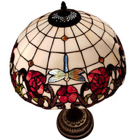 Decorative lamp with stained glass design featuring roses and a dragonfly 