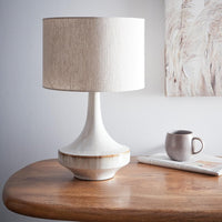 Modern ceramic table lamp with neutral beige glazed base and fabric drum shade